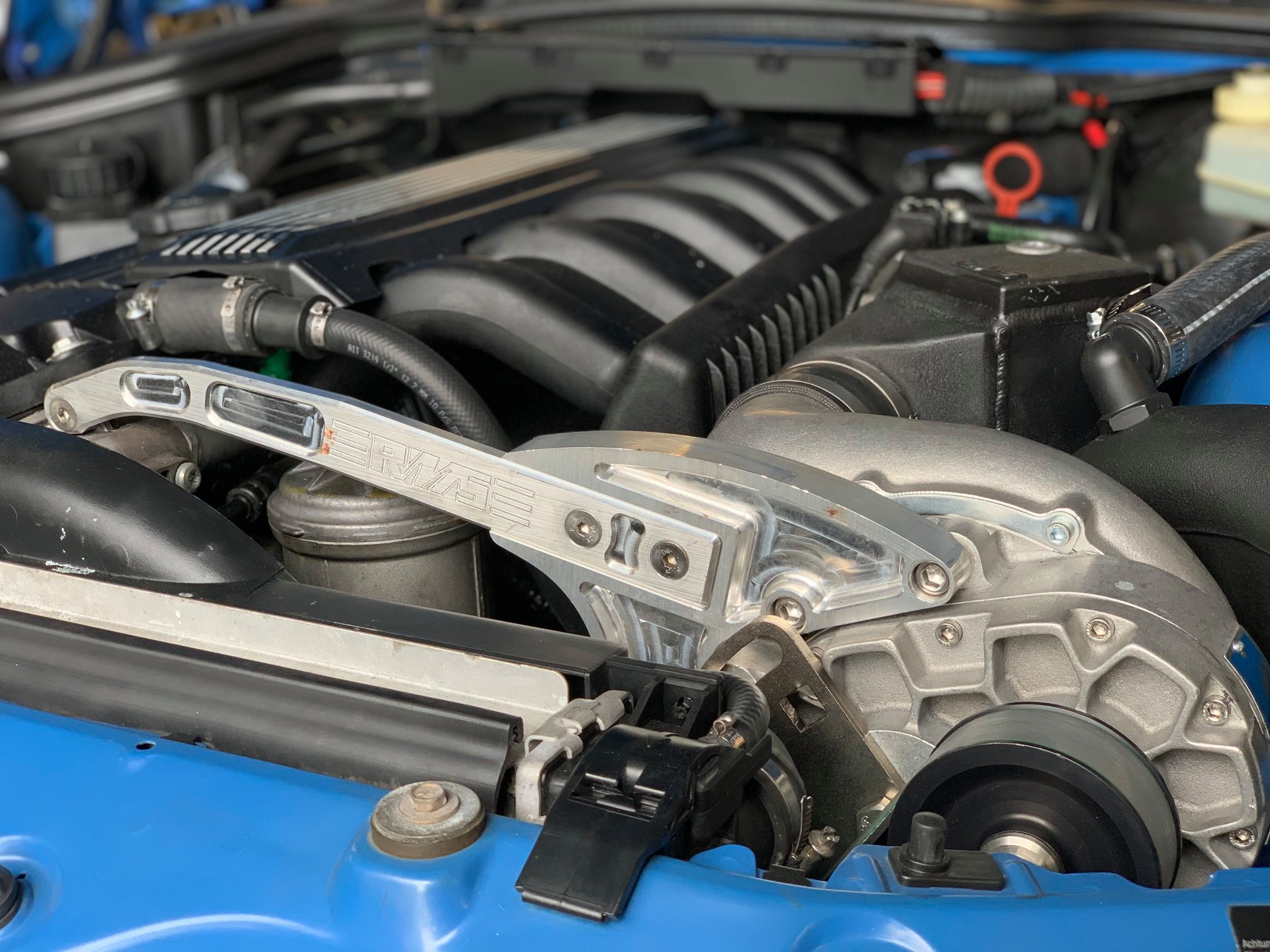 | Buckhead Imports Performance supercharger kit parts for BMW Z3 installation including pulleys, fan, and intake components